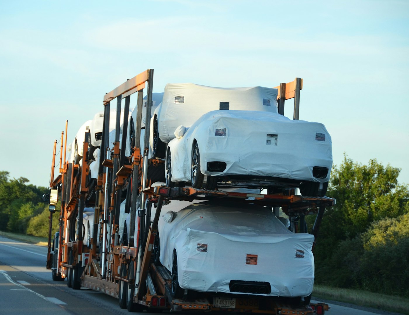 Covered cars on a car carrier